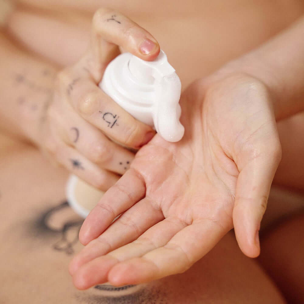 Sex Au Naturel Prebiotic Intimate Wash Gentle Foam being dispensed into a hand for gentle cleansing.