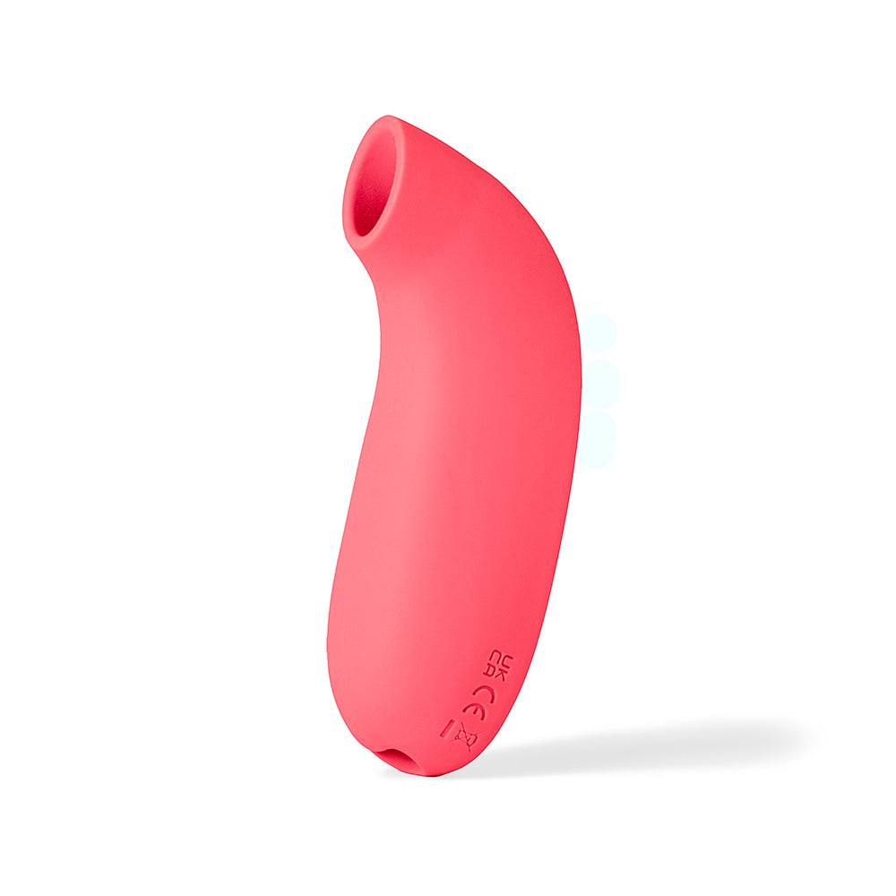 Dame Aer Suction Massager Coral side view showcasing its sleek design and innovative air pressure technology.