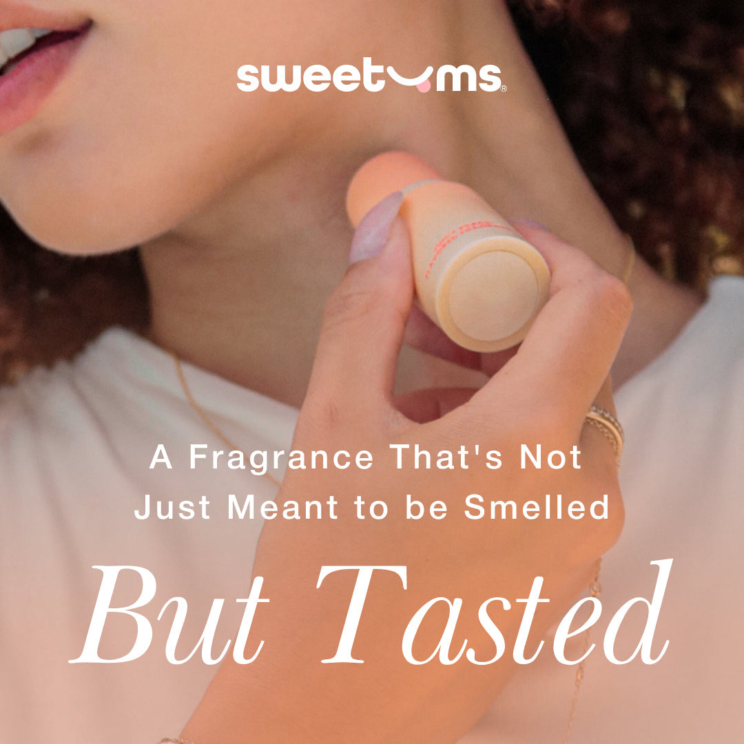 Sweetums Sweet Spot Flavored Fragrance Island Passion on a woman's wrist, showcasing its edible fragrance feature.