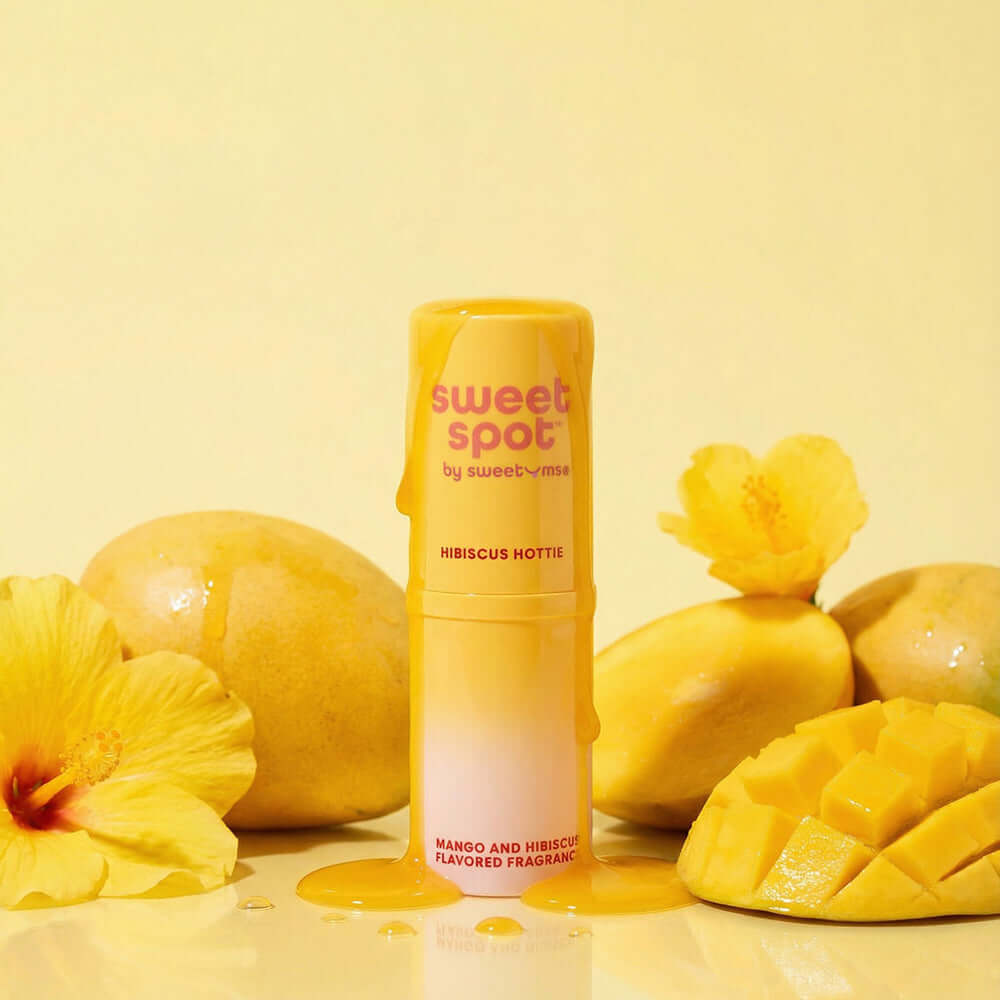Sweetums Sweet Spot Flavored Fragrance Hibiscus Hottie with mango and hibiscus against a bright yellow background.