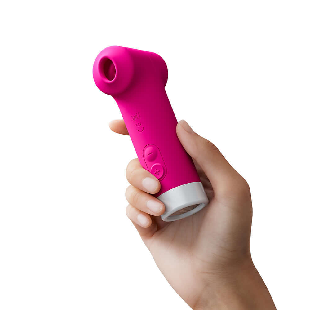 Lovense Fizz Oral-Like Suction & Tapping Massager in a hand, showcasing its vibrant pink design and ergonomic shape.