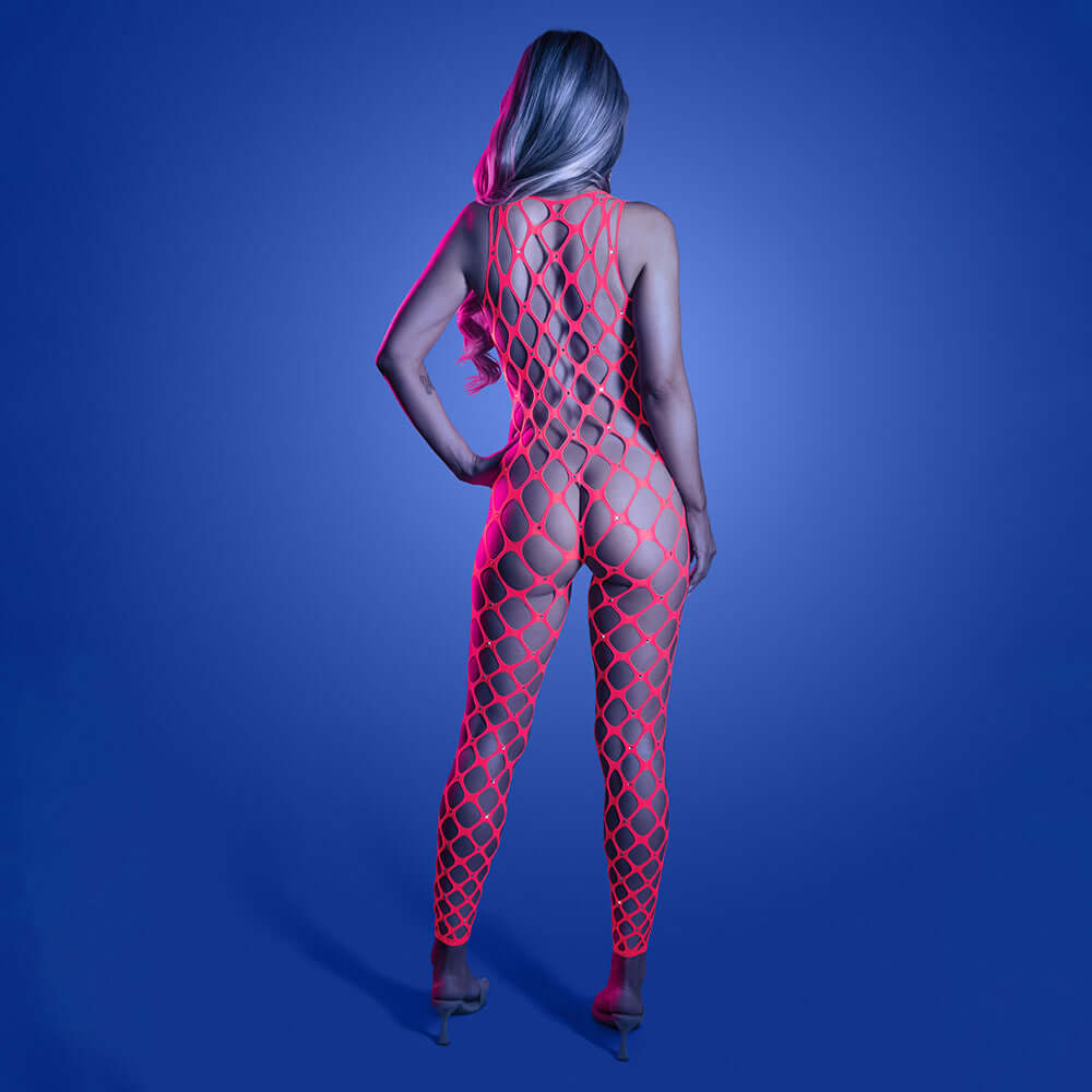Model showcasing the Fantasy Lingerie Glow Want It All Bodystocking & Pasties from the back against a blue background.