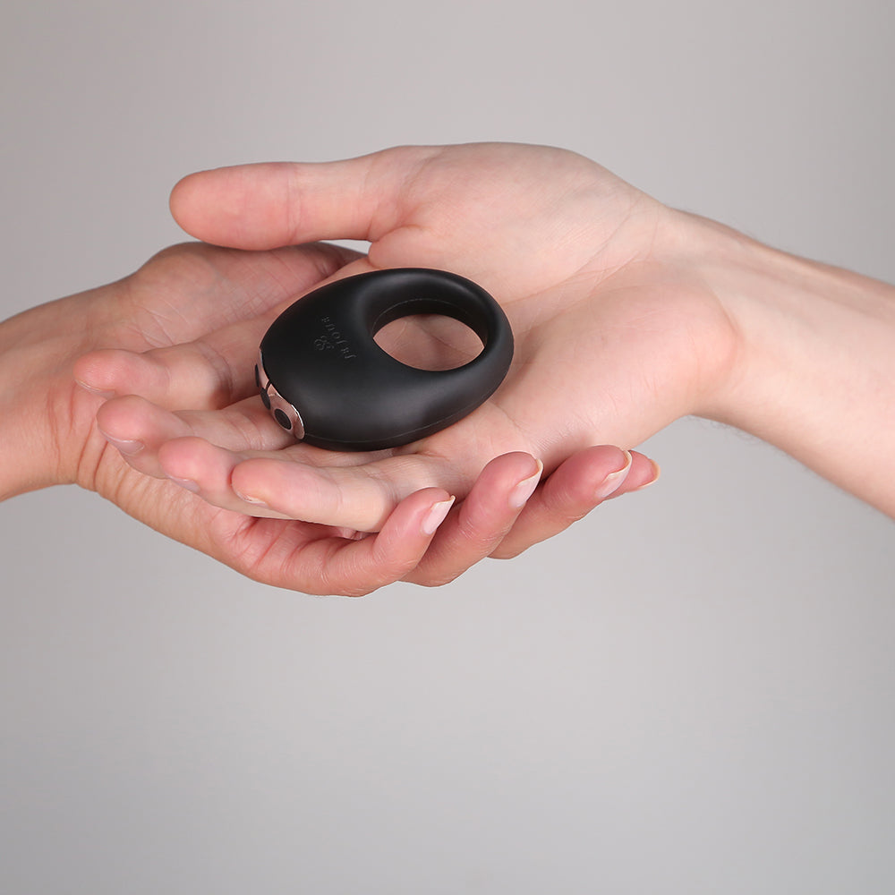 Je Joue Mio V2 Vibrating Cock Ring Black held in a hand, showcasing its sleek design and functionality.