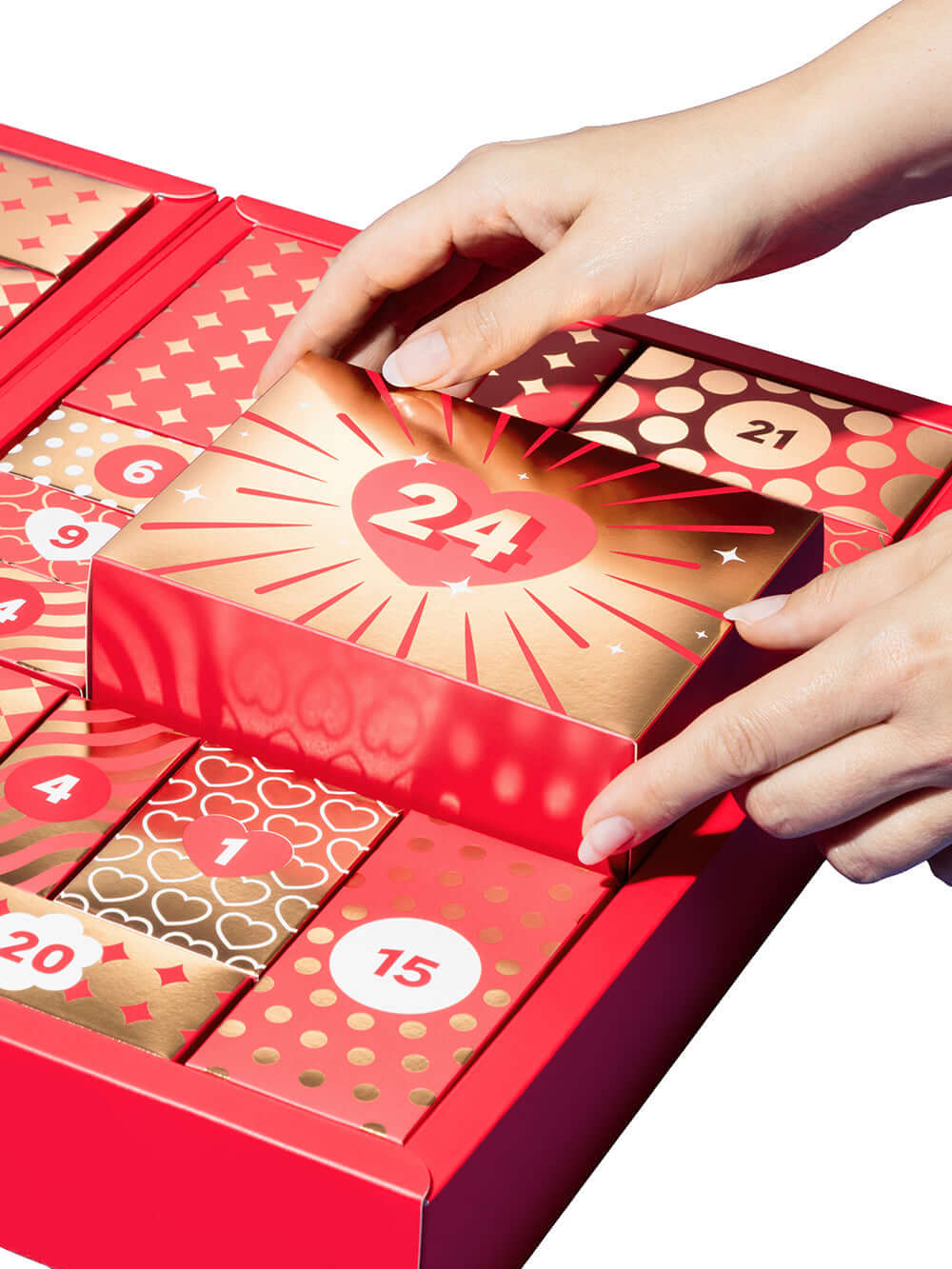 Lovehoney Womanizer We-Vibe Couples Advent Calendar 2026 with hand opening the 24th box, revealing holiday treats.