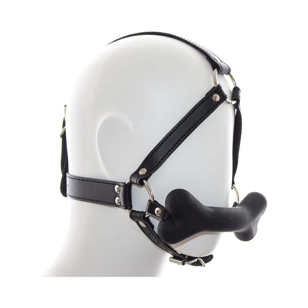 Ple'sur Face Harness Dog Bone Gag featuring a black harness and playful bone-shaped bit for pup play.