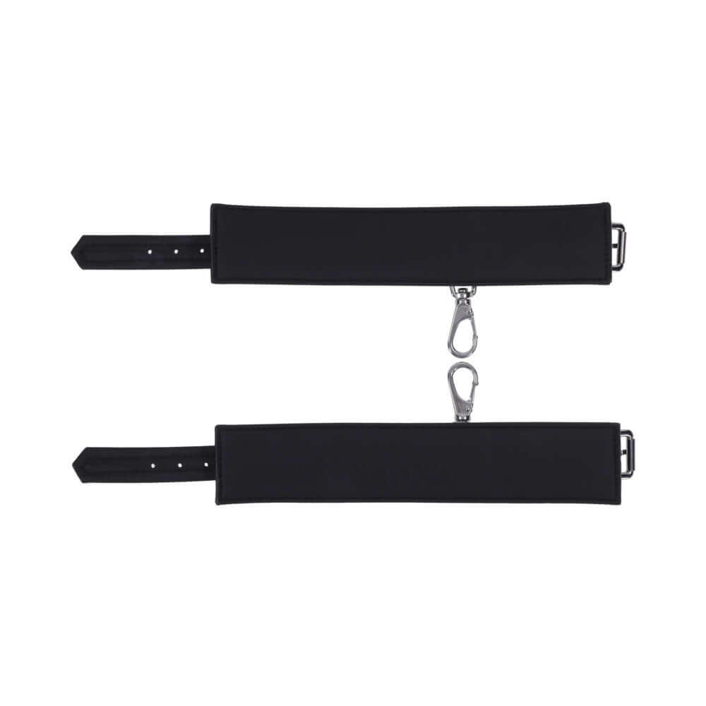 Sportsheets Signature Midnight Muse Ankle Cuffs in sleek black silicone with silver-tone hardware for comfortable restraint play.