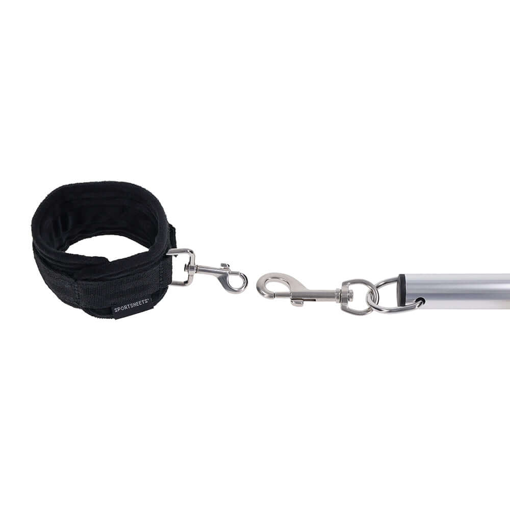 Sportsheets Signature Adjustable Spreader Bar with black cuff and metal clasps for versatile restraint.
