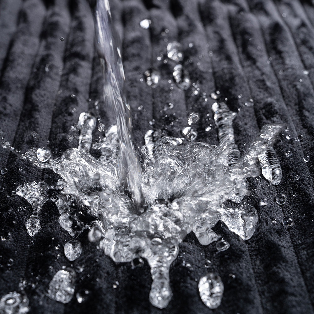 Water splashing on the Sportsheets Signature Waterproof Blanket, demonstrating its protective and waterproof features.