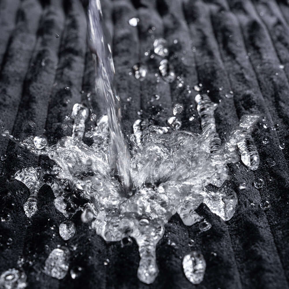 Water splashing on the Sportsheets Signature Waterproof Blanket, demonstrating its protective and waterproof features.