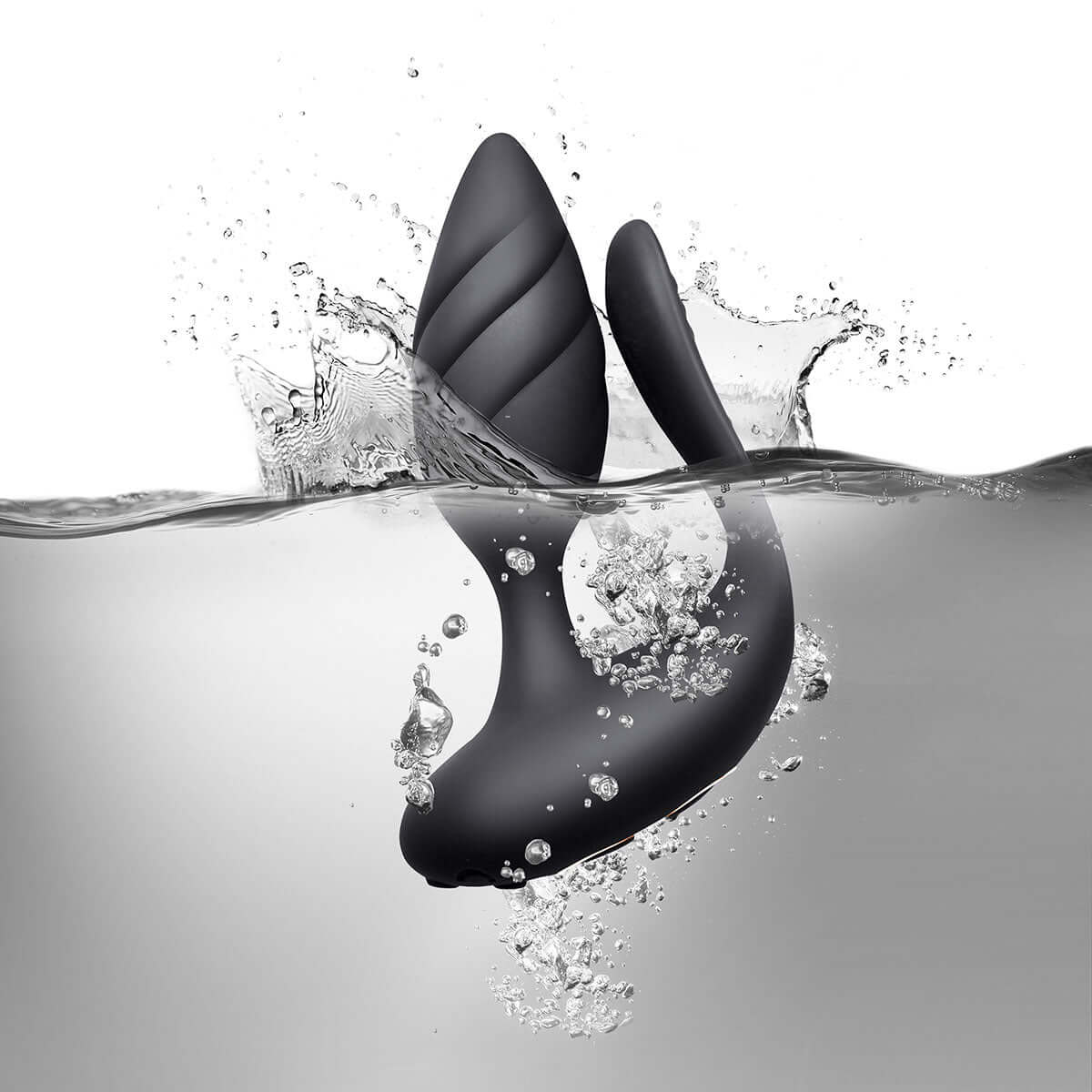 Cocktail Couples Vibrator with Remote Control submerged in water with splashes, showcasing its elegant design and functionality.