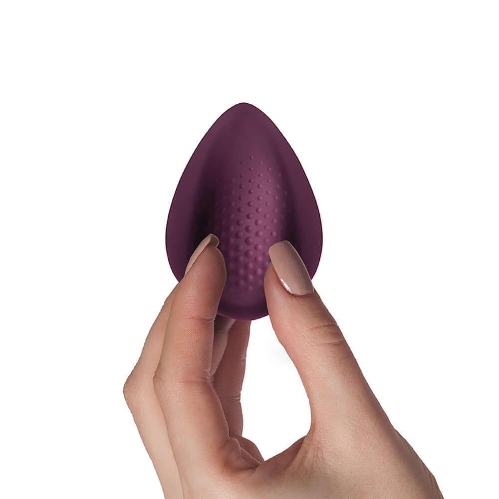 Knickerbocker Glory Panty Vibe Burgundy held in hand, showcasing its velvety body-safe silicone design for discreet stimulation.