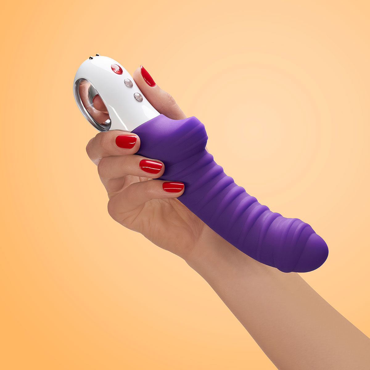 Fun Factory Tiger Vibrator Magenta in hand, showcasing its textured, wavy shaft and ergonomic design.
