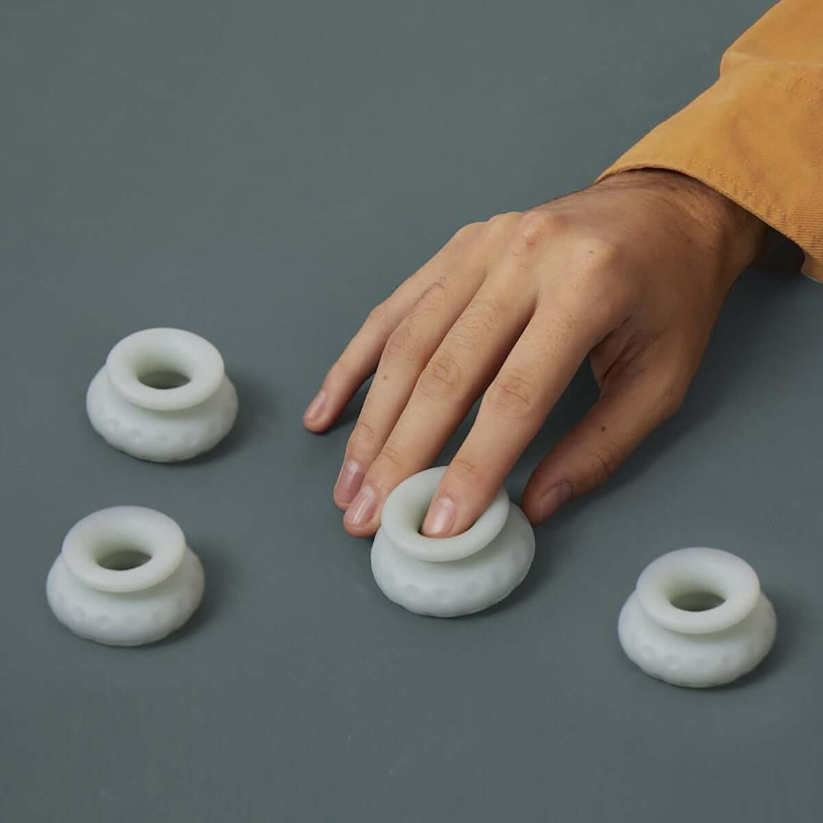 Ohnut Depth-Limiting Rings 4-Pack Jade displayed with a hand demonstrating their use.