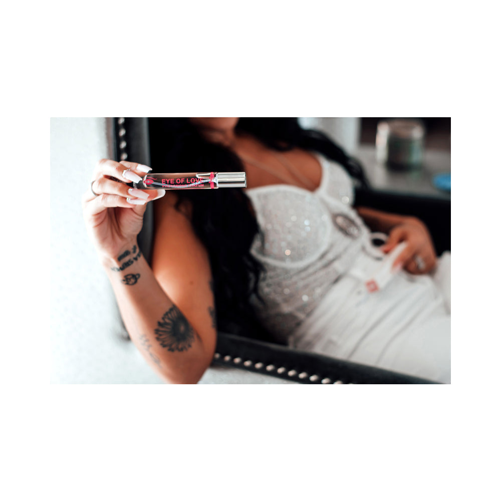 Model showcasing Eye of Love One Love Attract Him Pheromone Parfum 10 ml in a sparkly top.