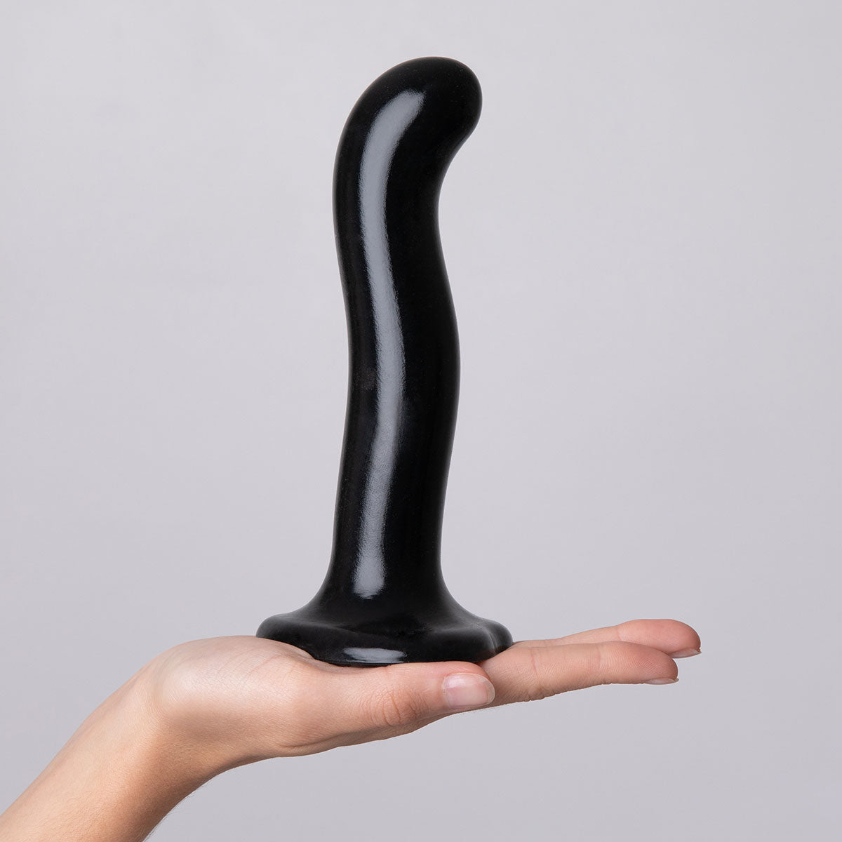 Strap-on-me P & G-spot Dildo Black Small held in a hand showcasing its ergonomic design and body-safe silicone material.