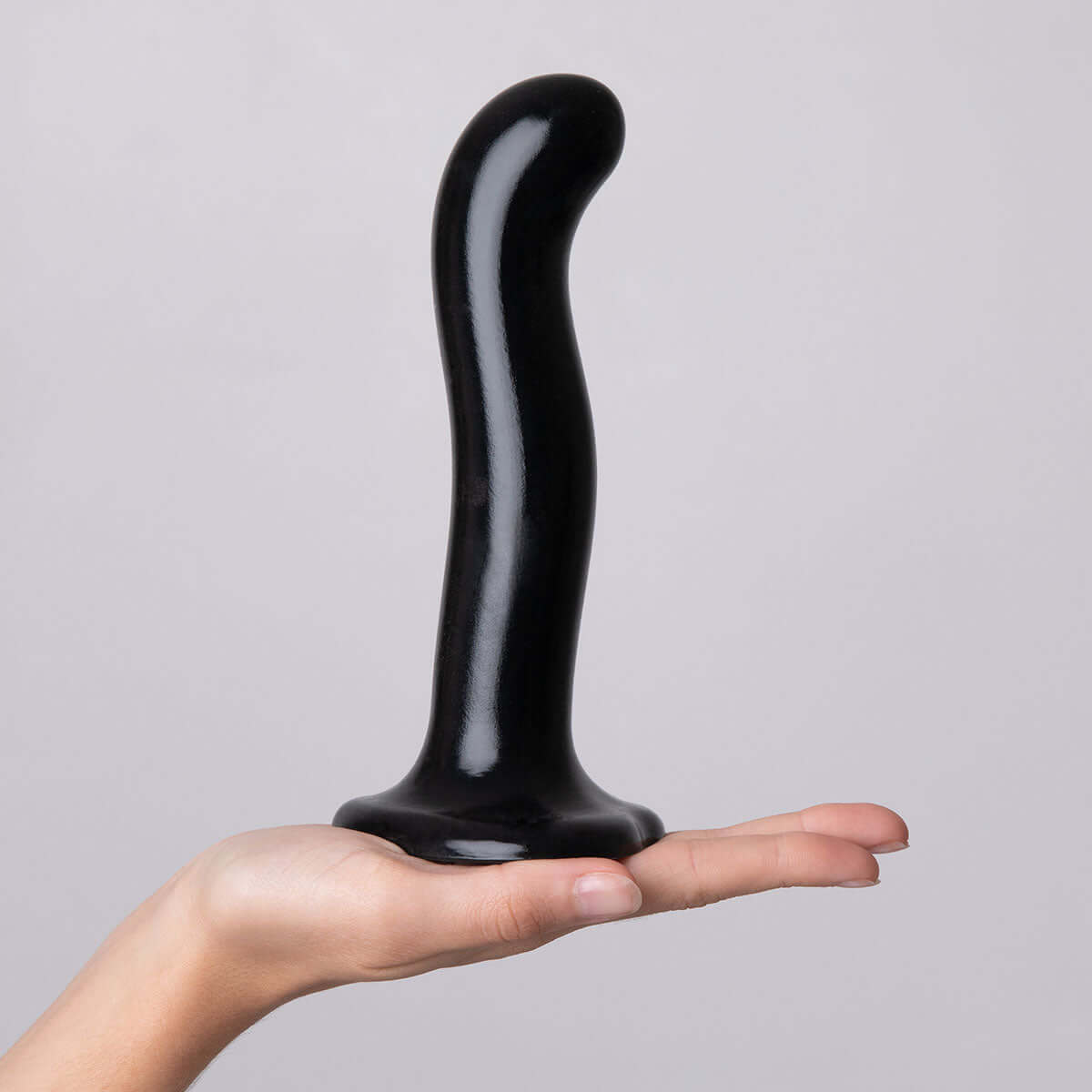 Strap-on-me P & G-spot Dildo Black Small held in a hand showcasing its ergonomic design and body-safe silicone material.