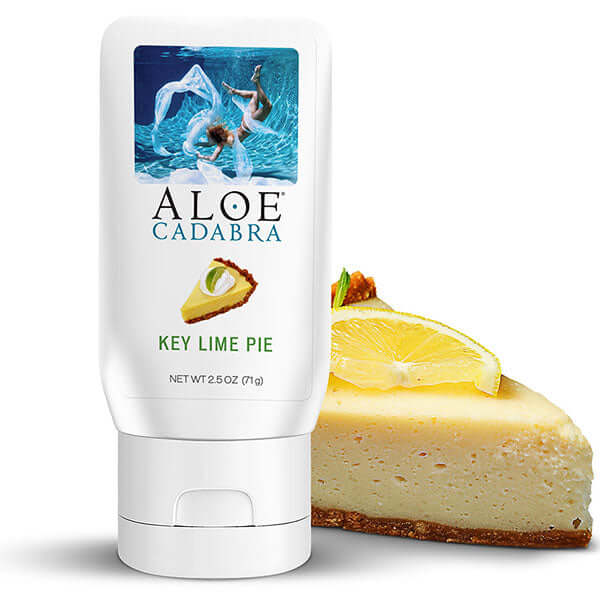Aloe Cadabra Organic Lubricant Key Lime 2.5 Oz packaging beside a slice of key lime pie.