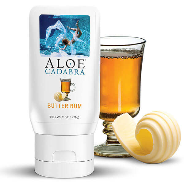 Aloe Cadabra Organic Lubricant Butter Rum 2.5 Oz bottle next to a glass of butter rum and a swirl of butter.