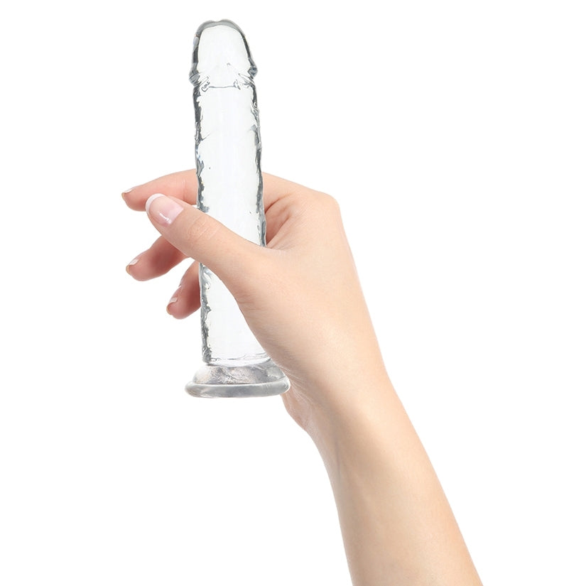 Person holding the Crystal Addiction 7 Inch Straight Dong Suction Cup with a clear and smooth design.