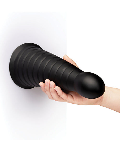 b-Vibe Cone 10 inch Tapered & Ribbed Dildo with Suction Cup held by a hand against a white background.