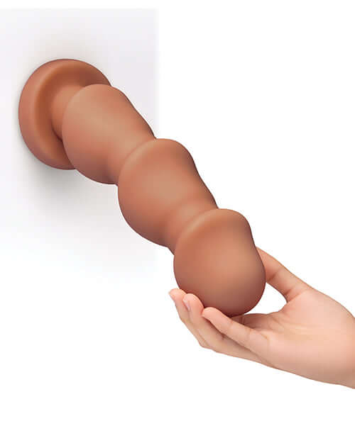 b-Vibe Headz 10.5 inch Multi-Bulb Dildo with Flared Base, showing hand holding the dildo with spaced bulbs on the shaft.