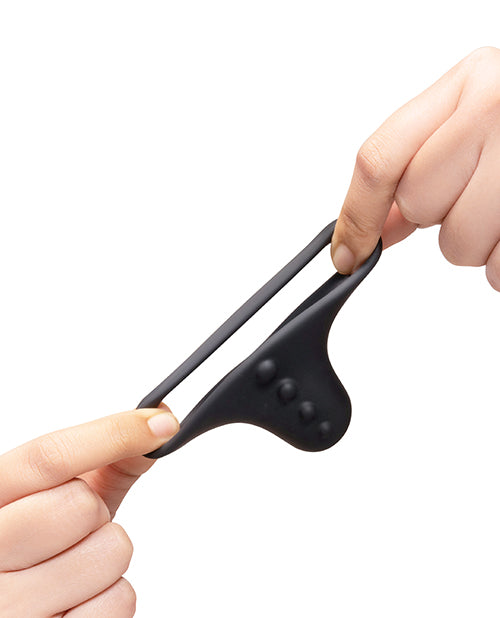 b-Vibe Flex Ring Shaft Silicone Cock Ring & Ball Stretcher being stretched by hands, showcasing its flexible design.