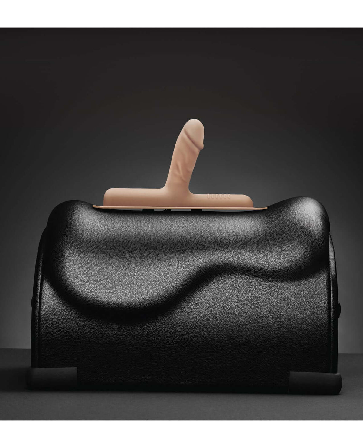 The Cowgirl Bronco Silicone Attachment Vanilla on a black sex machine, showcasing its realistic design and color.