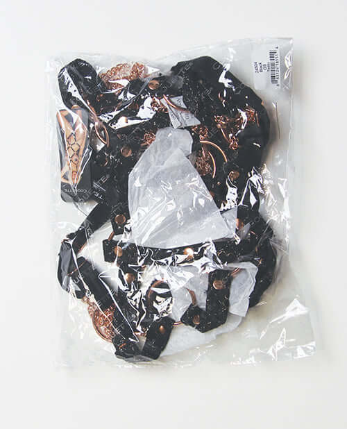Coquette Your Command Harness Teddy Black Rose Gold in clear packaging with black straps and rose gold hardware.