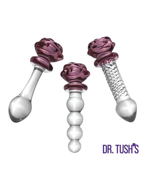 Dr Tush's Sacred Glass Rose Anal Plug Set featuring three hand-blown glass pieces with purple rose accents.