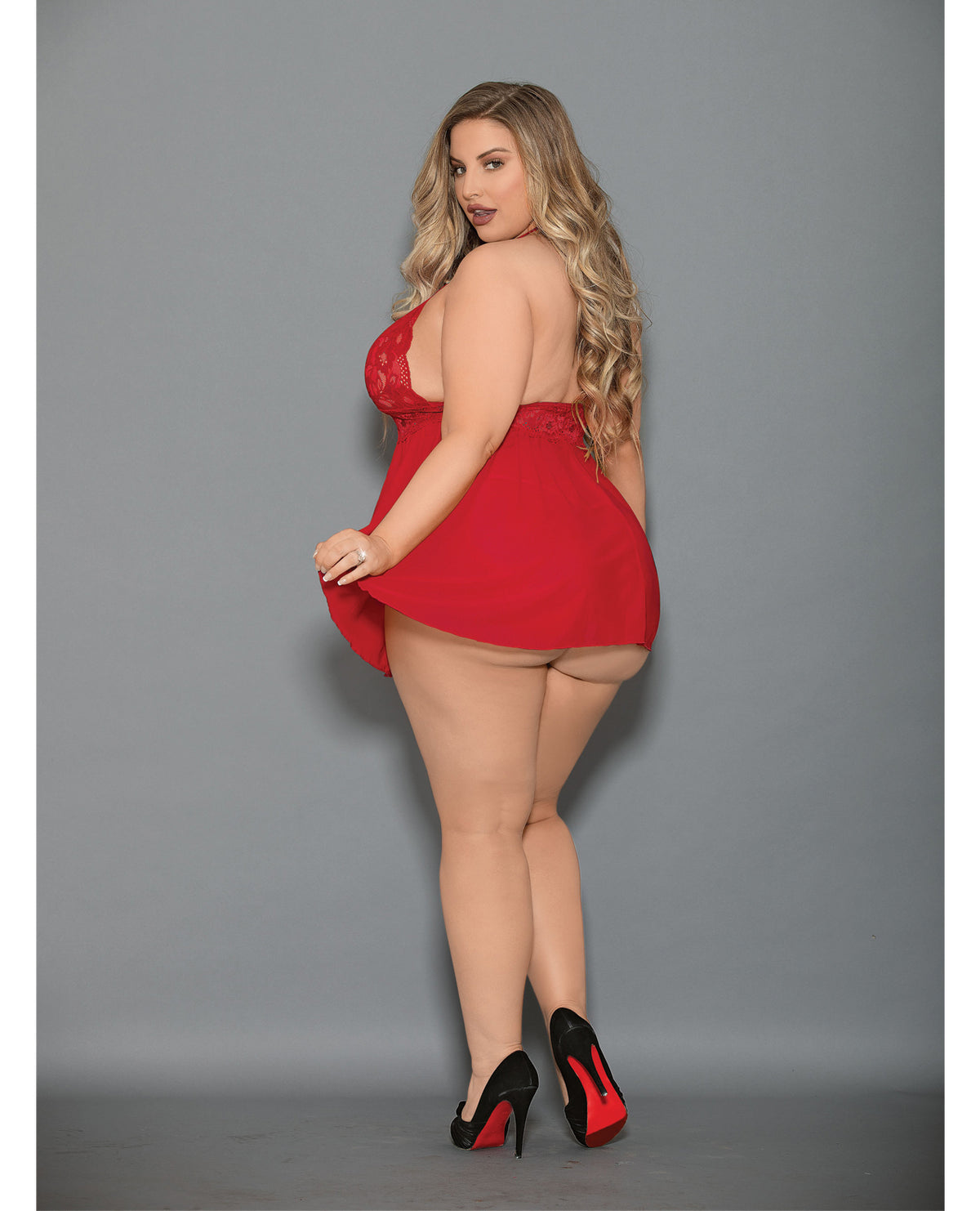 Model wearing Euphoria Shorty Babydoll and Open Panty Red Queen set in red, showcasing sheer mesh and lace design from the back.