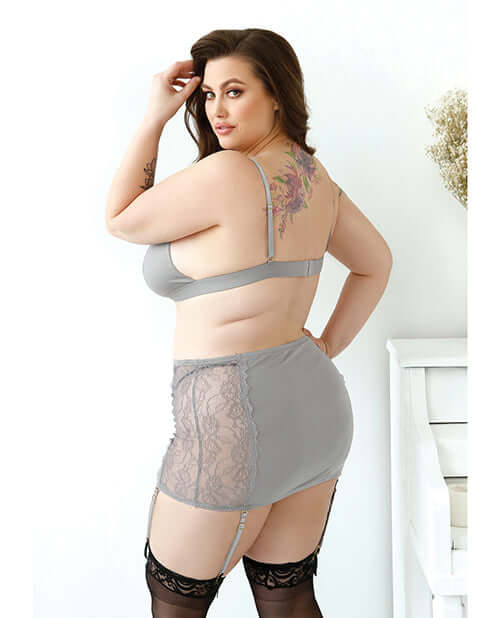 Model wearing the Curve Layne Lace Bralette Garter Set Gray 3X 4X from the back, showcasing the lace skirt and bralette.
