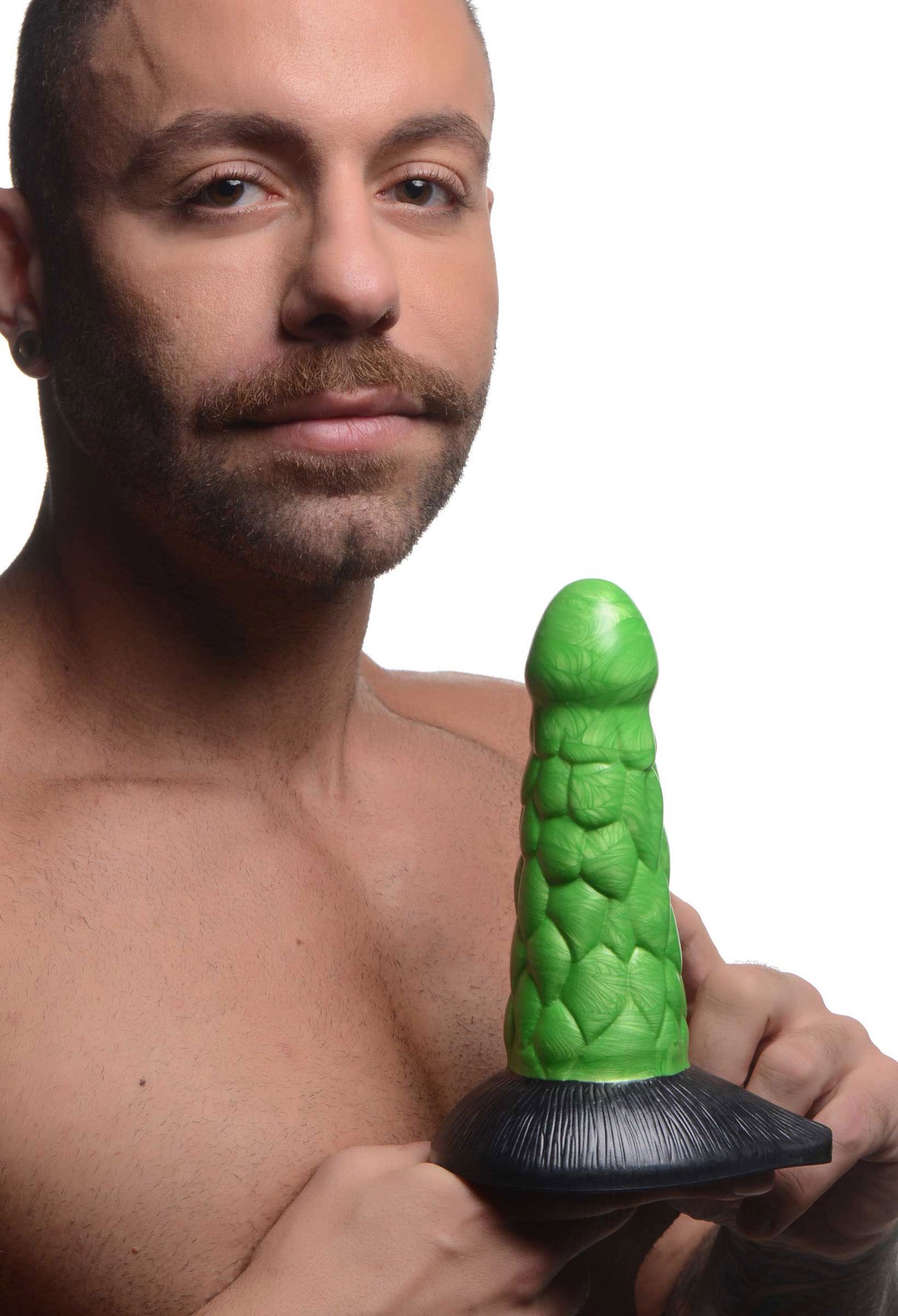 Radioactive Reptile Thick Scaly Silicone Dildo Green held by a model, showcasing its dragon-inspired texture and vibrant color.