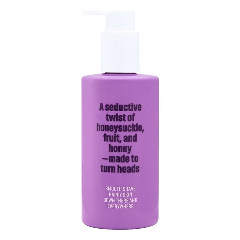 Coochy Shave Cream Flirty Blooms 8 Oz bottle featuring a glossy purple design and smooth shave promise.