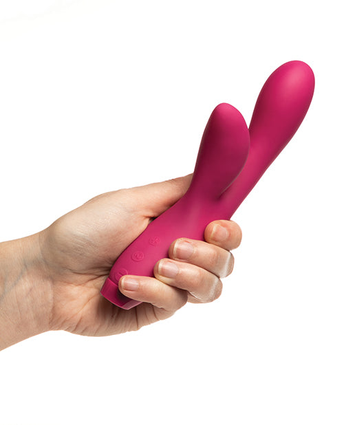 Je Joue Hera Rabbit Vibrator Fuchsia held in hand, showcasing its sleek design and dual stimulation features.