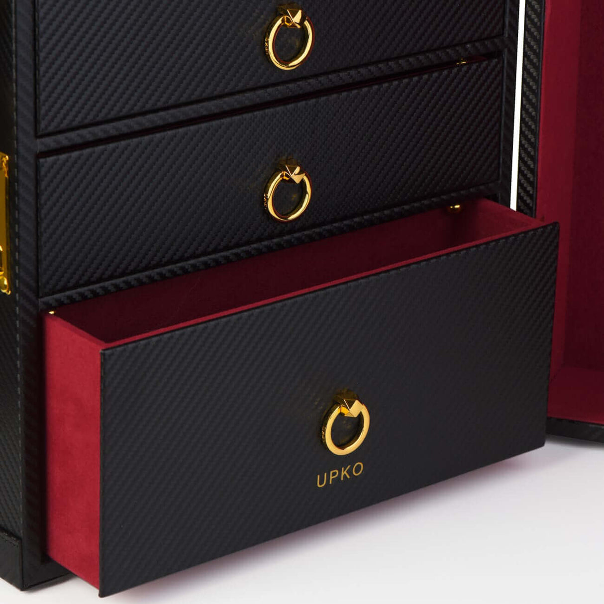 Luxury bondage trunk drawer showcasing UPKO logo and red velvet lining, crafted with elegant black faux leather.