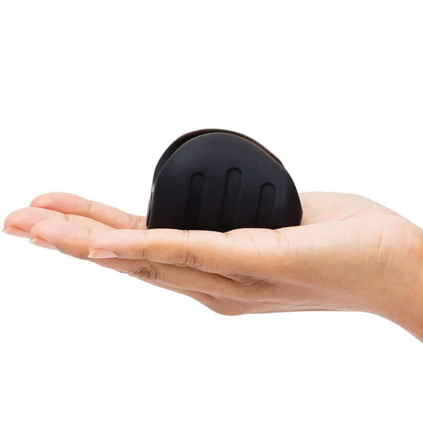 Fifty Shades Of Grey Sensation Vibrating Pleasure Stroker held in hand, showcasing its silky-soft texture and compact design.