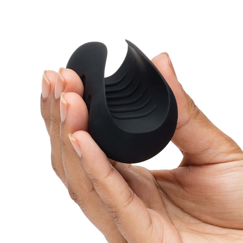 Fifty Shades Of Grey Sensation Vibrating Pleasure Stroker held in hand, showcasing its silky-soft texture and flexible design.