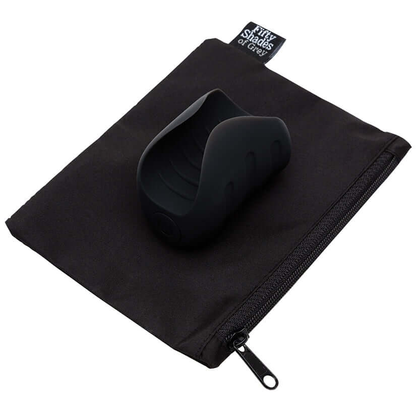 Fifty Shades Of Grey Sensation Vibrating Pleasure Stroker on a black pouch, showcasing its sleek and modern design.