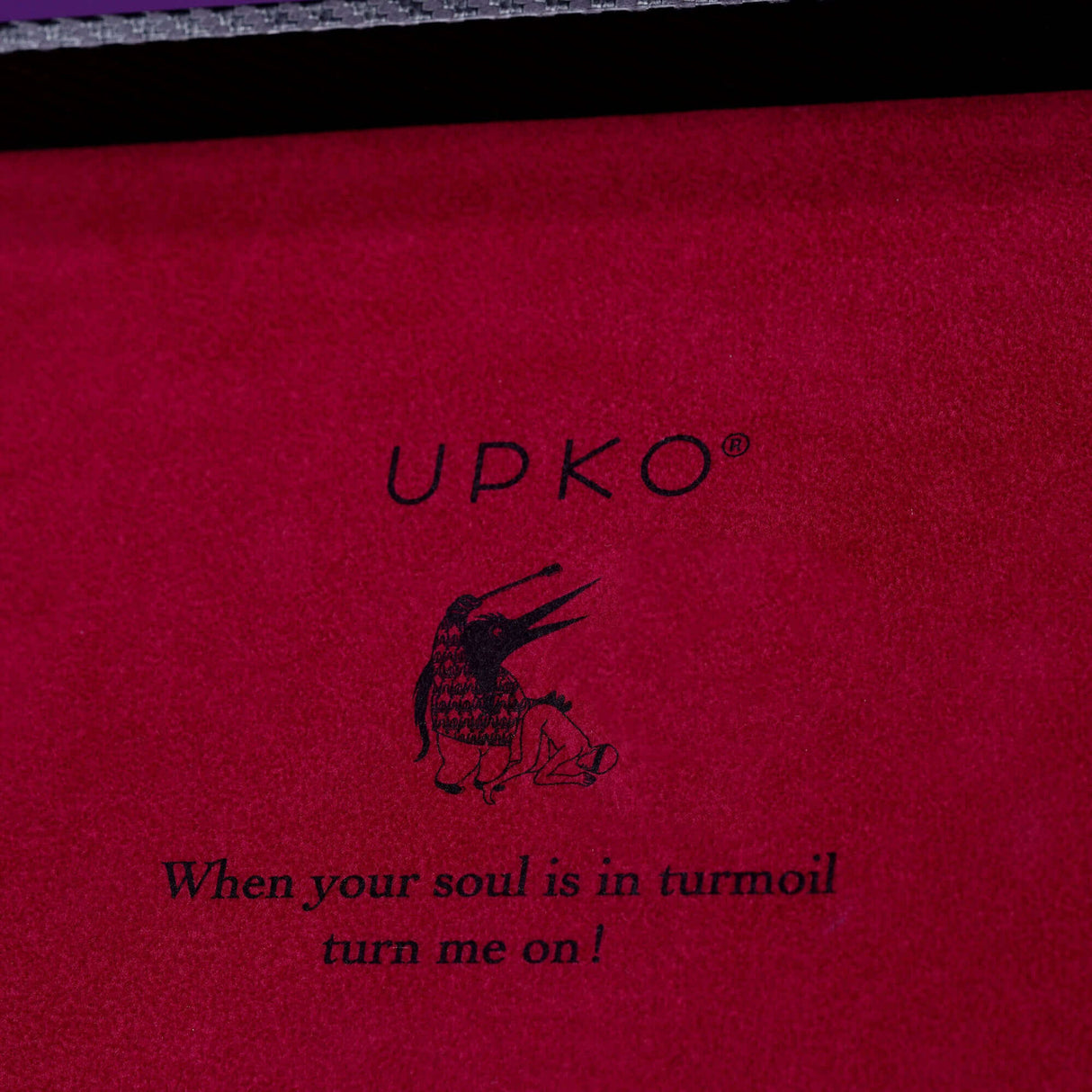 UPKO luxury bondage case interior with artistic penguin design and quote "When your soul is in turmoil, turn me on!"