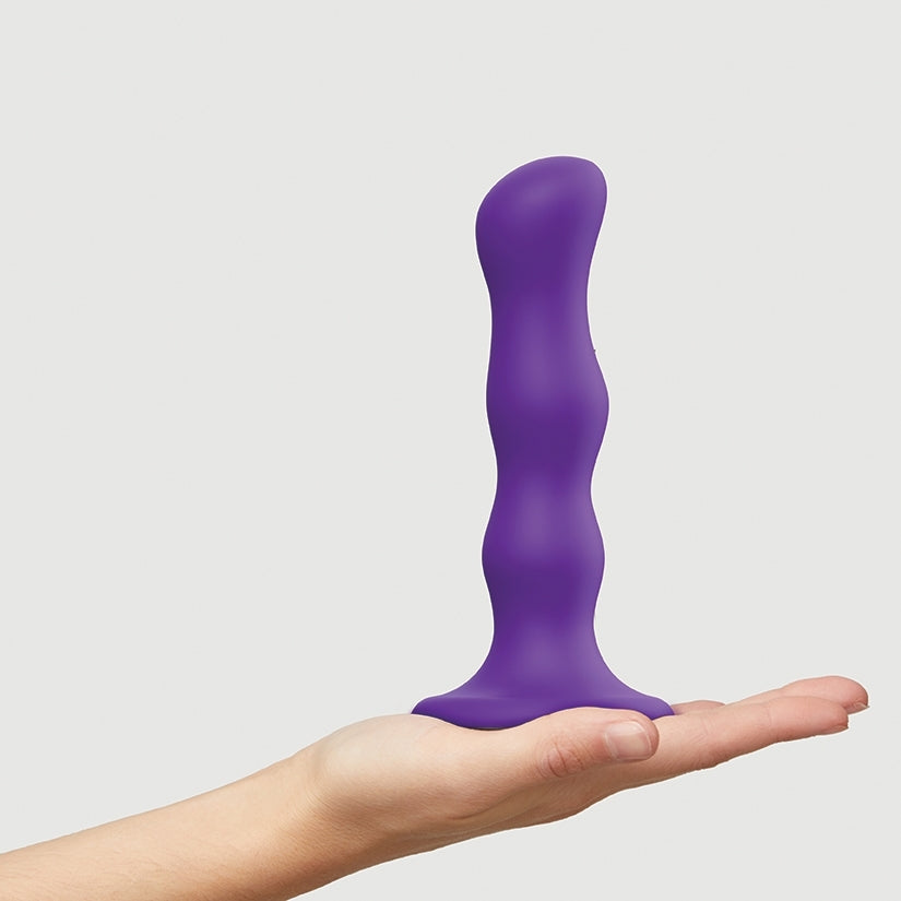 Strap On Me Geisha Dildo With Balls Purple M held in hand, showcasing its ergonomic design and soft touch.