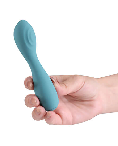 X & Os Cherish Silicone Rechargeable Vibe Teal held in hand, showcasing its smooth silicone design and ergonomic shape.