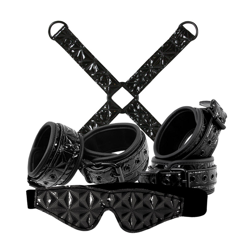 NS Novelties Sinful Bondage Kit Black with wrist cuffs, ankle cuffs, and blindfold arranged stylishly.
