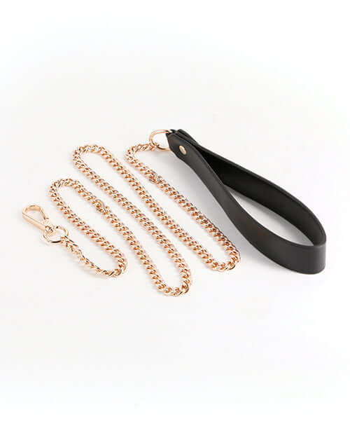 Fetish & Fashion Nyx Leash Black, featuring a black handle and gold chain for bondage play and stylish restraint.