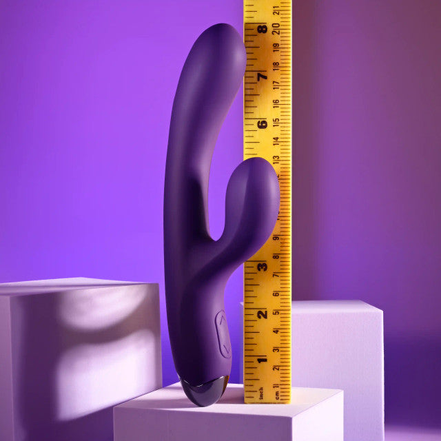 Playboy New Crush Rechargeable Dual Vibrator next to a measuring tape for size comparison.