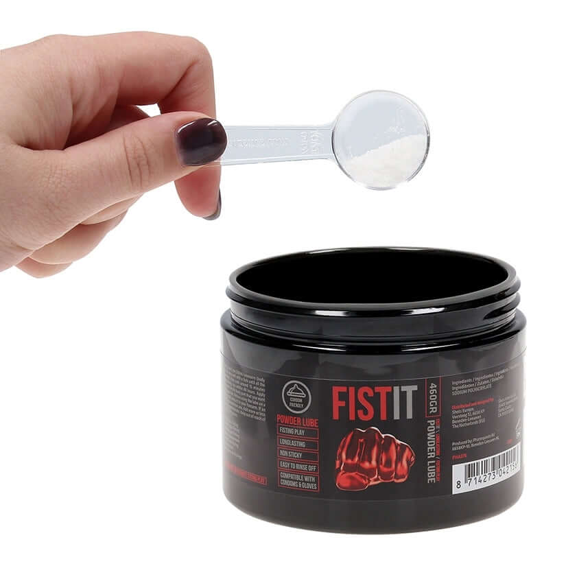 Fist It Powder Lube Fisting Lubricant 16.2 Oz with a scoop of powder being prepared for mixing.
