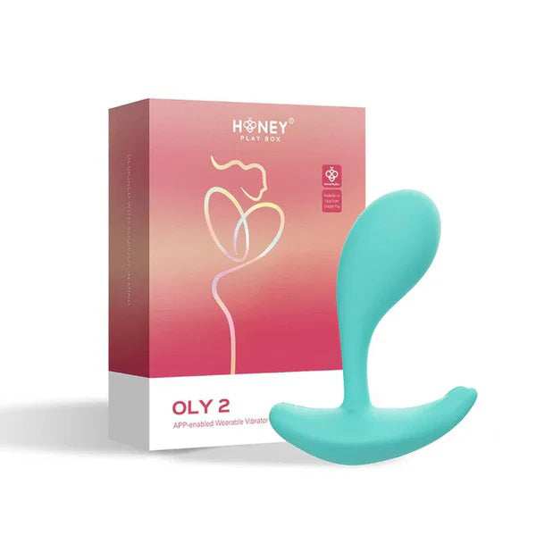 Oly 2 App-Enabled Wearable Vibrator Blue next to its packaging, showcasing a sleek design for intimate pleasure.