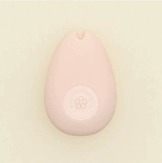 Tenga Iroha Sakura Silicone Clitoral Vibrator Pink on a soft background, showcasing its ergonomic design and button.