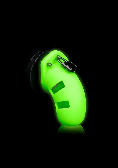 Ouch Model 20 Cock Cage 3.5 Inch Glow in the Dark Green on a black background, highlighting its unique design.