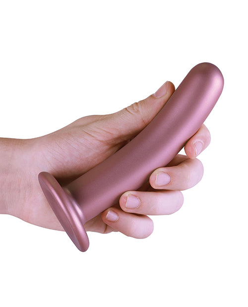 Shots Ouch 6 inch Smooth G-Spot Dildo Rose Gold held in a hand showcasing its sleek design and suction cup base.