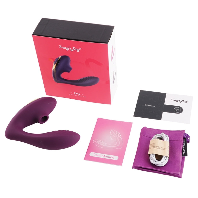 Tracy's Dog OG Clitoral Sucking Vibrator Purple with packaging and accessories surrounding it.